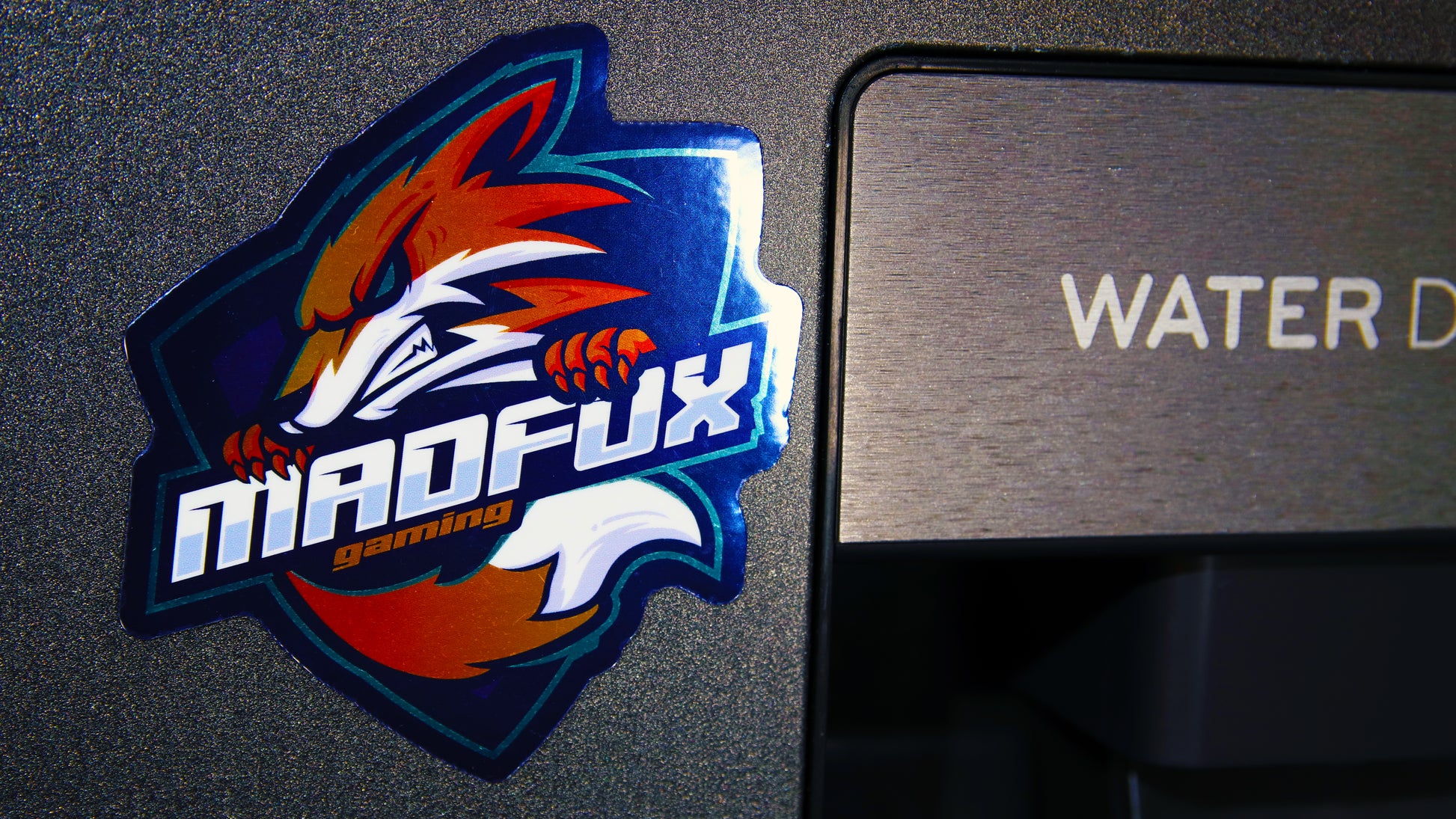 Custom-shaped die-cut mirror silver magnet stuck to a water dispenser