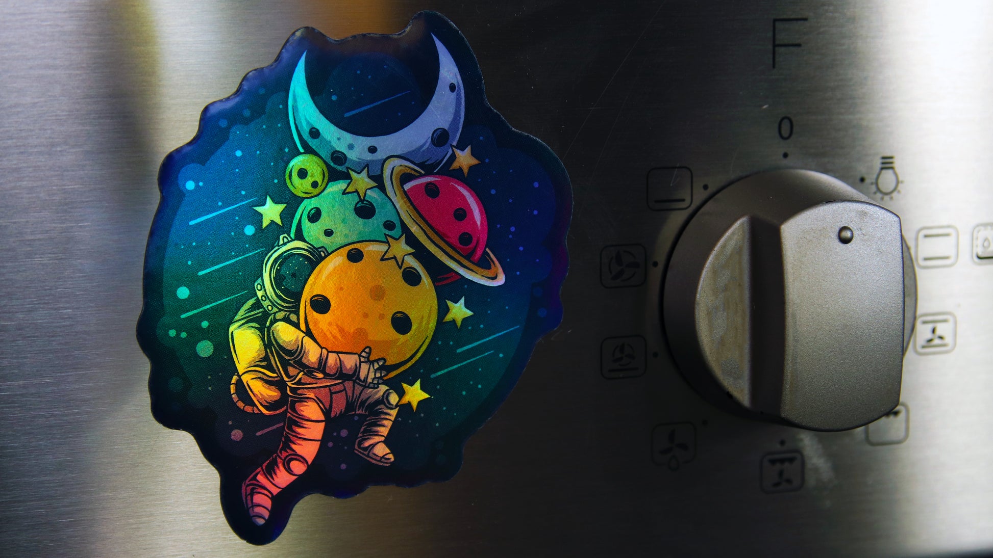 Custom-shaped die-cut magnet applied to a metal oven