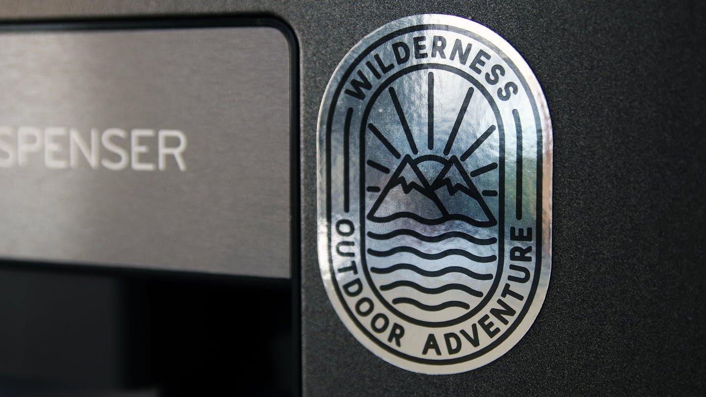 Metallic silver oval custom printed magnet attached to a water dispenser