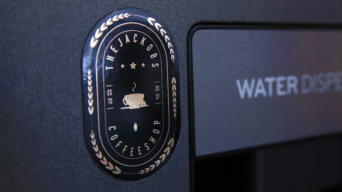 Oval magnet printed on gold effect material with Coffee logo design