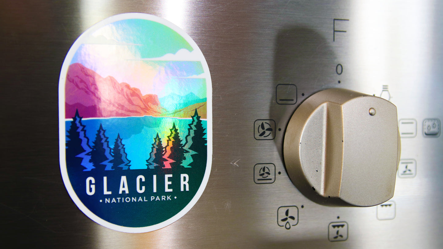 Oval shaped magnet with a Glacier National Park design printed on it