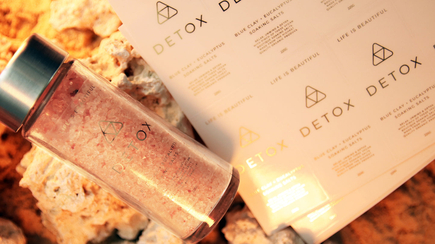 Rectangle eco-friendly gold foil label applied to a clear jar next to sheets oh labels