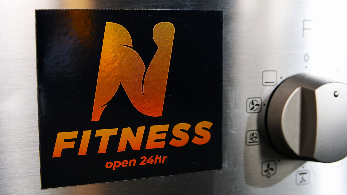 Custom silver magnet cut to a square shape stuck to an oven