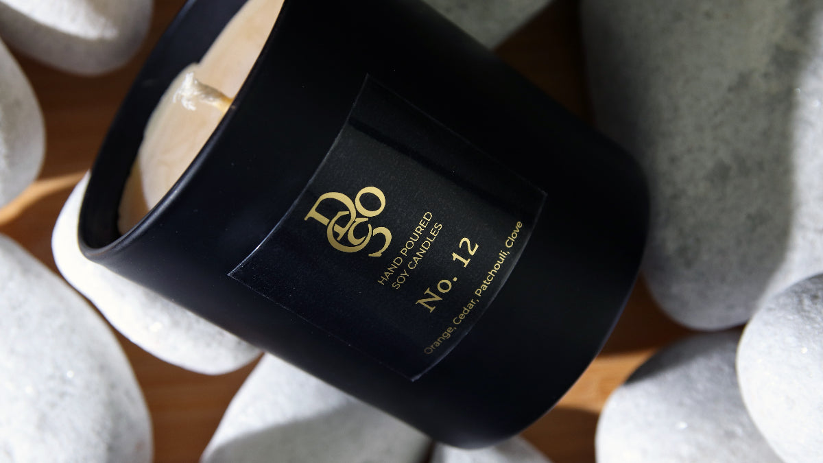 Square eco-friendly gold stickers applied to a black candle jar