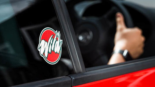 Die cut white vinyl sticker with wild logo applied to car window