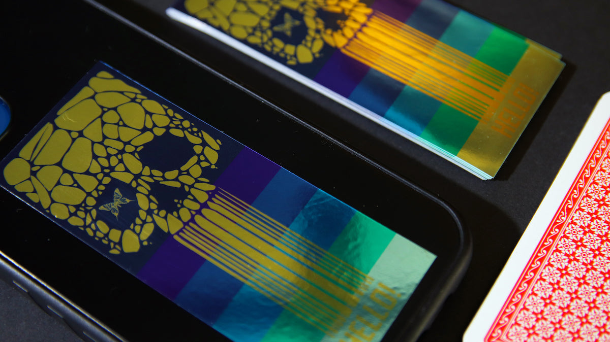 Gold skull metallic sticker applied to an iPhone