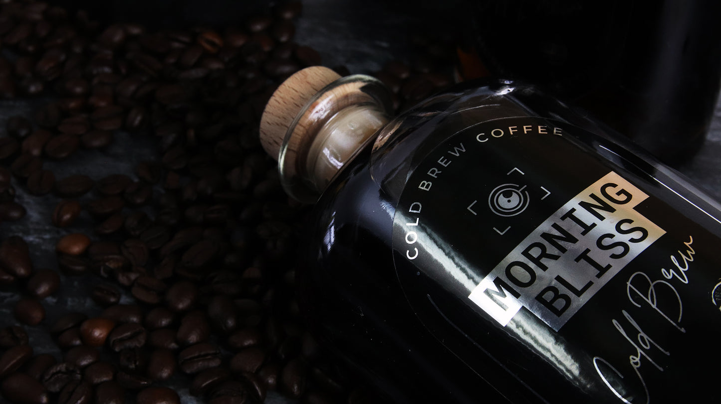 Oval labels with morning bliss design applied to a glass bottle with cold brew coffee
