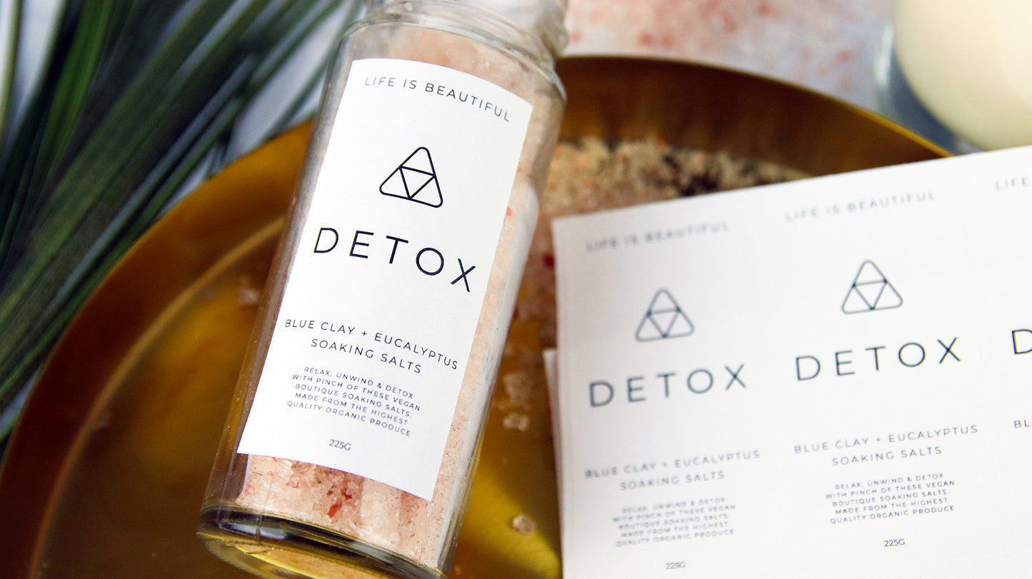 Rectangle biodegradable paper compostable labels with detox design applied to a clear glass jar filled with soaking salts