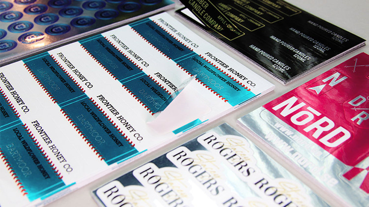 Stacks of mirror silver weatherproof labels on a table