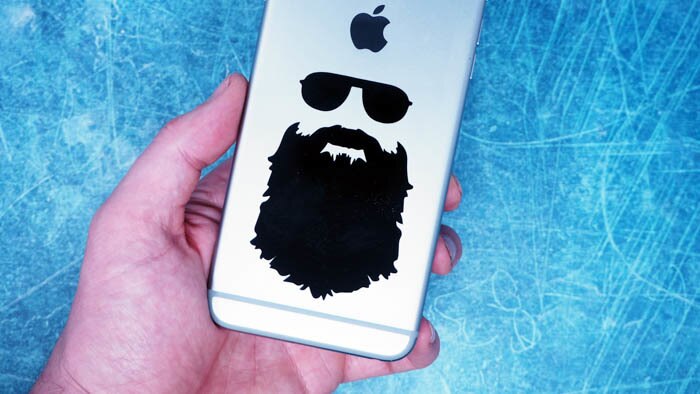 Black transfer sticker with custom design applied to a silver phone