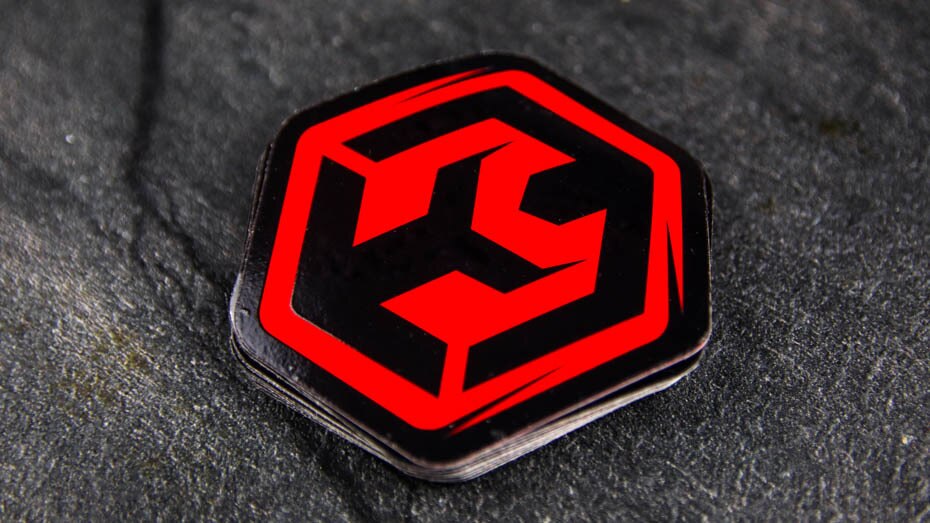 Die cut fluorescent red stickers on a table