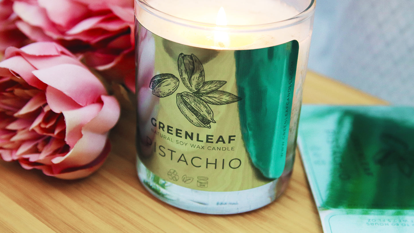 Die cut silver labels with one applied to a candle jar