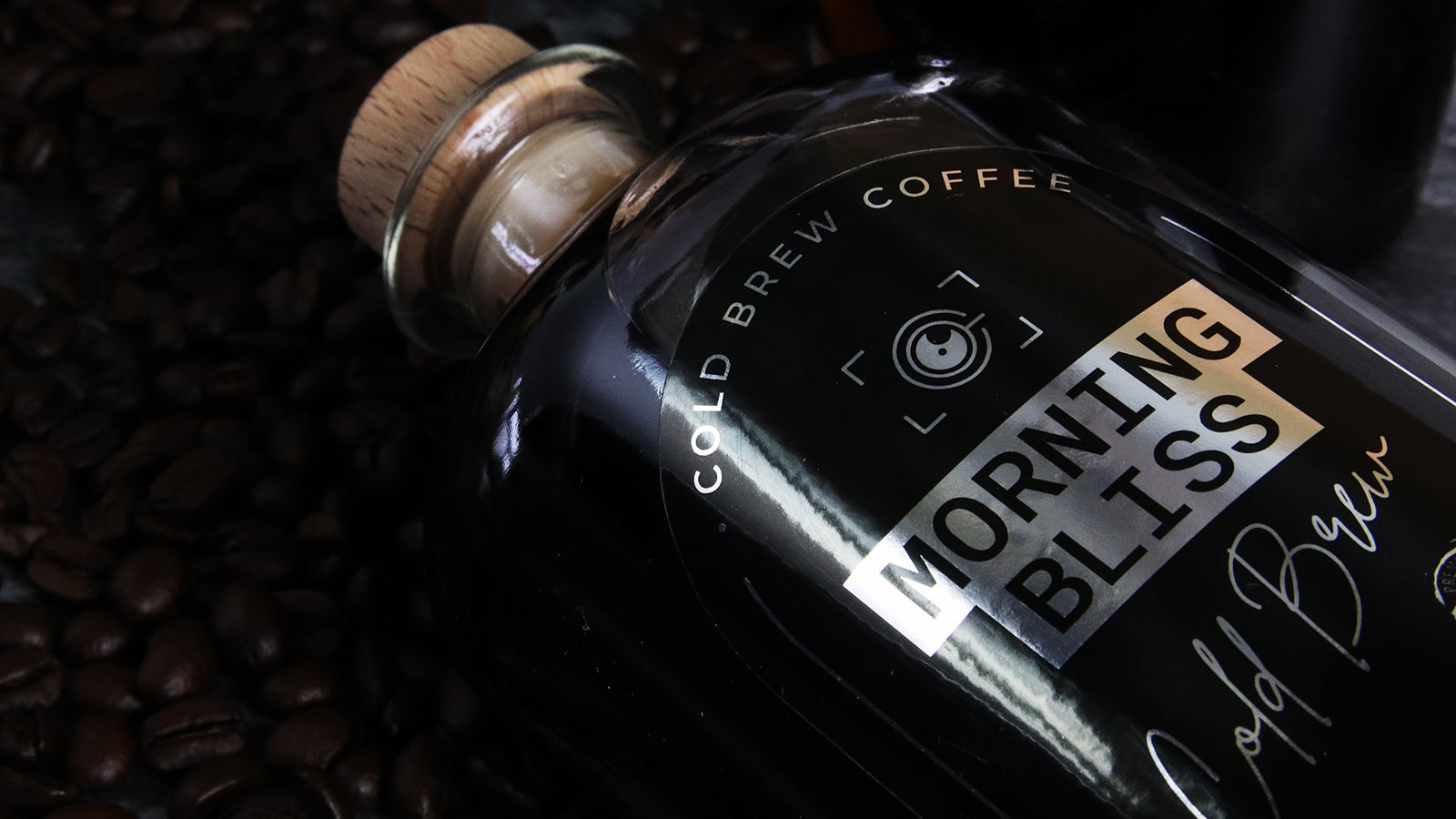 Mirror silver sticker with morning bliss design applied to a glass bottle with cold brew coffee
