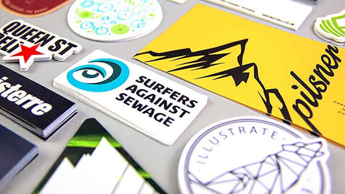 Piles of biodegradable paper stickers on a light grey table