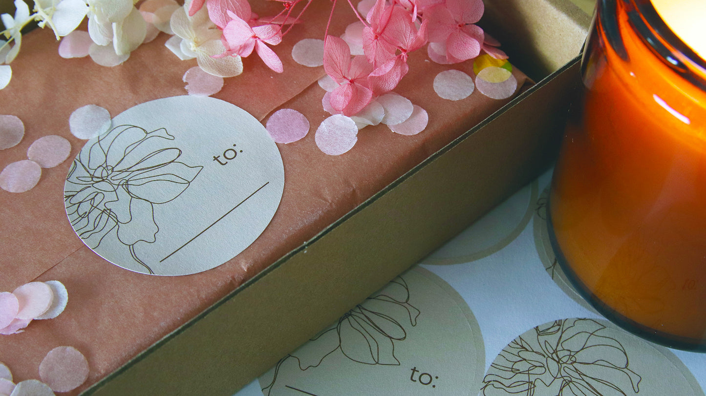 Circle biodegradable paper sheet label with space to write on applied to tissue paper used to protect products in a cardboard box