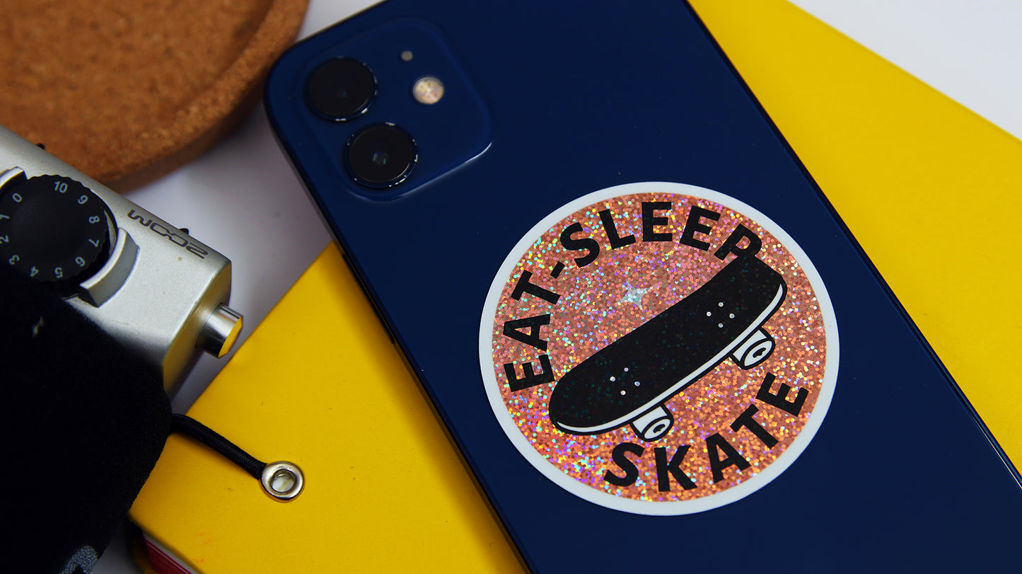 Circle eco-friendly glitter sample with skate design applied to a blue iPhone