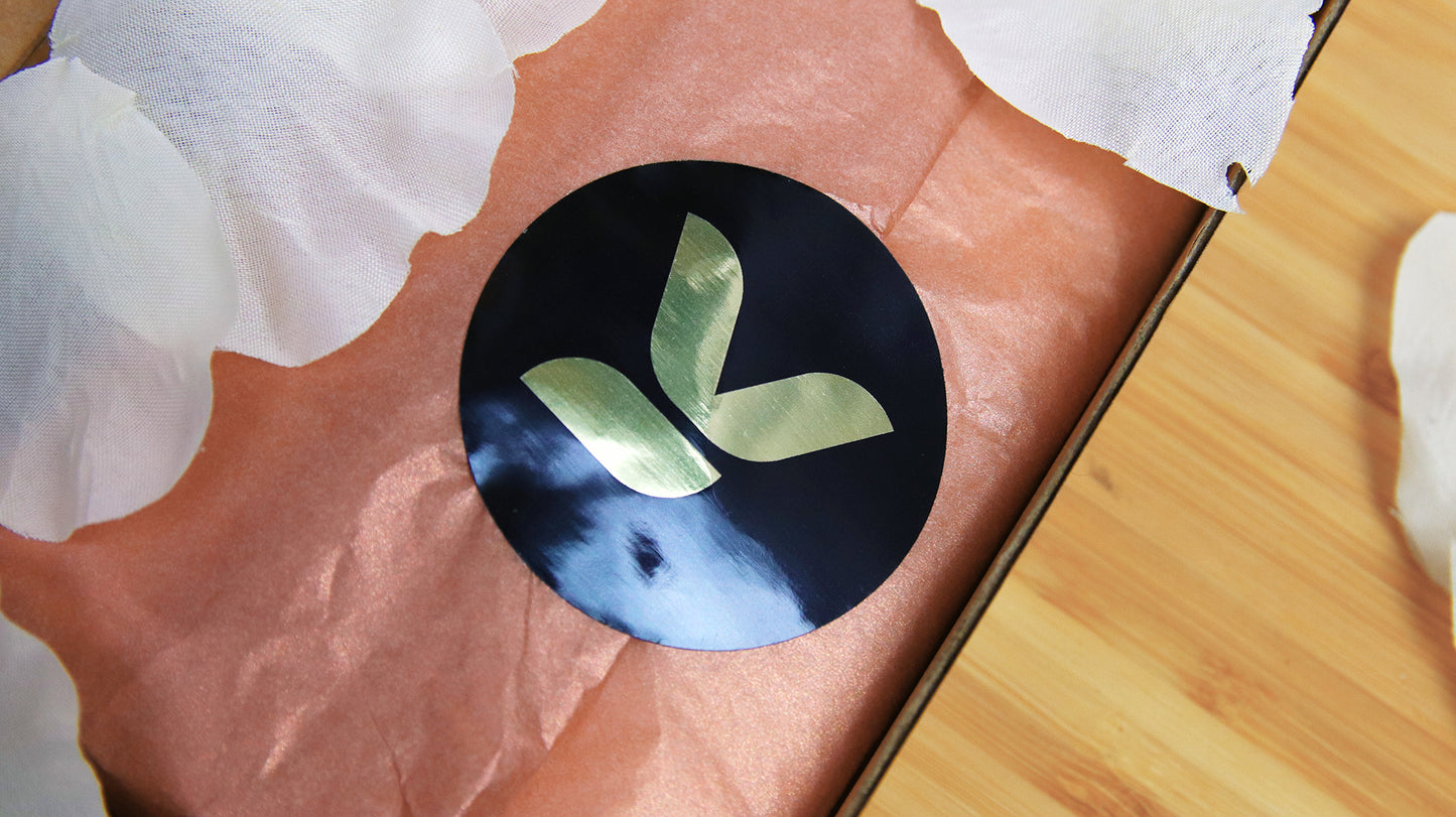 Circle eco-friendly gold sample with signature brand logo applied to seal packaging