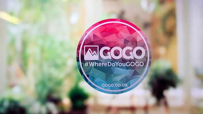 Circle static cling sticker with gogo logo applied to a window