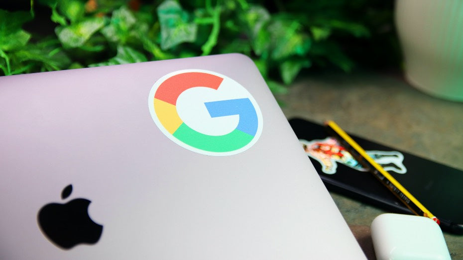Circle white vinyl sticker with Google logo on a MacBook laptop
