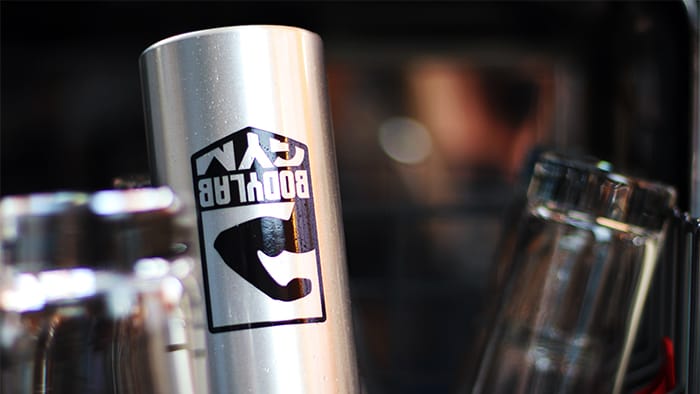 Clear die cut waterproof sticker applied to a stainless steel bottle in the dishwasher