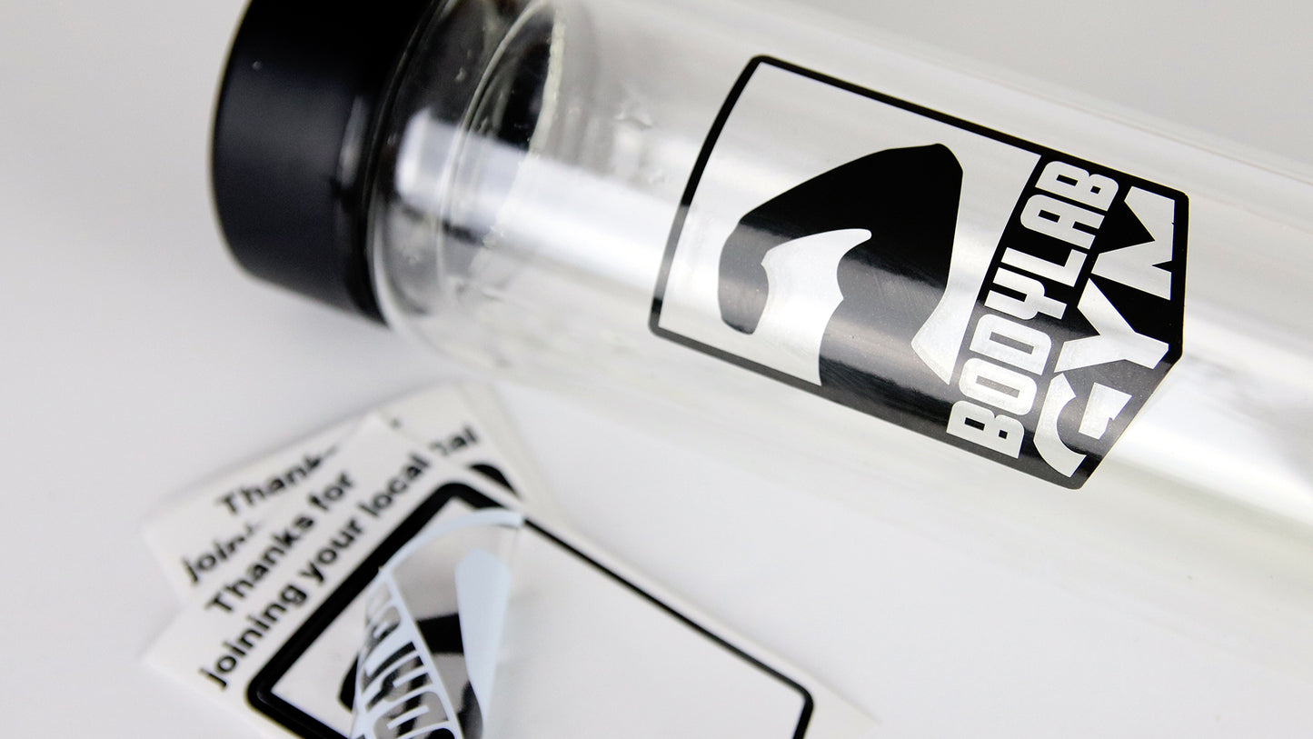 Clear kiss cut stickers some peeled and one applied to a clear water bottle