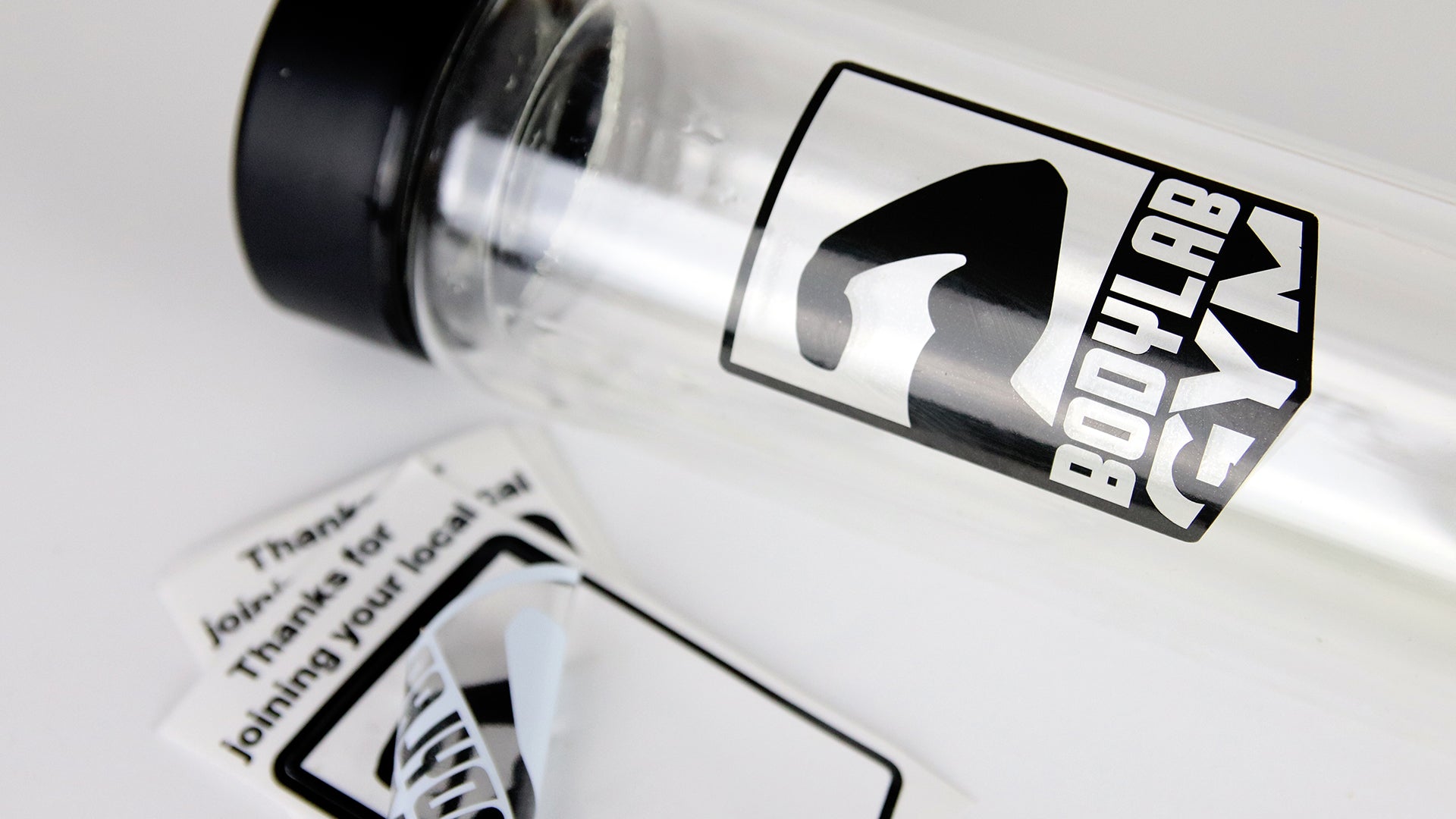 Clear kiss cut stickers some peeled and one applied to a clear water bottle