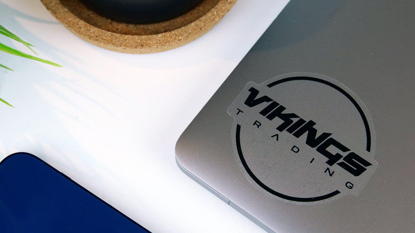 Die cut clear sticker with vikings logo applied to a silver laptop