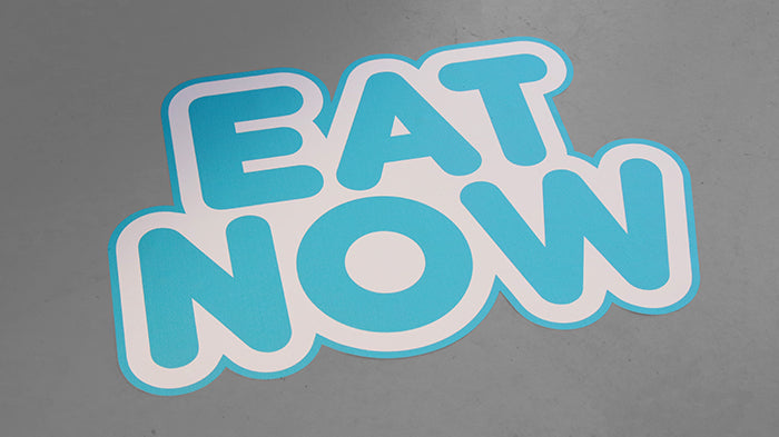 Die cut floor sample with eat now logo applied