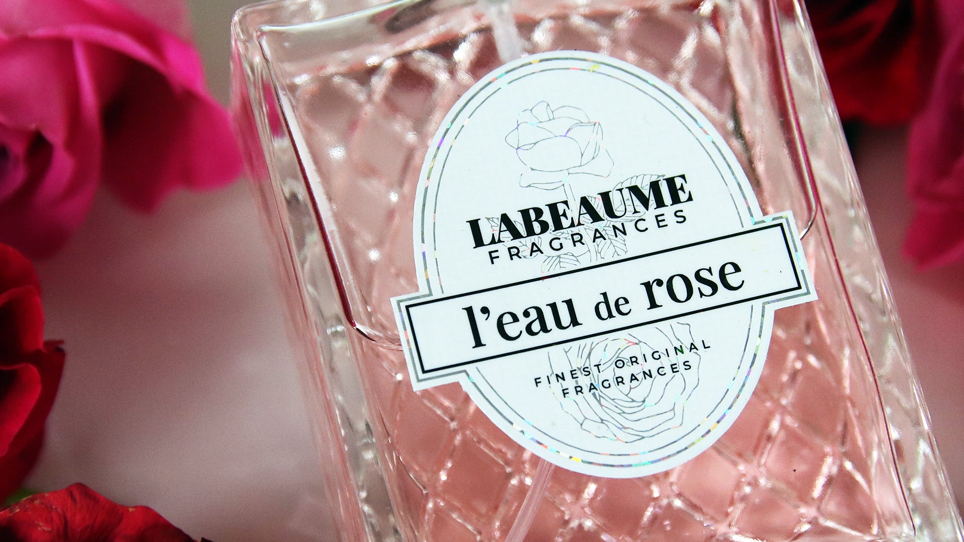 Die cut glitter label applied to rose scented perfume bottle