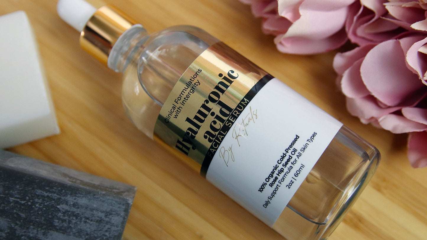 Eco-friendly gold sticker with hyaluronic acid facial serum logo applied to a clear cosmetics bottle