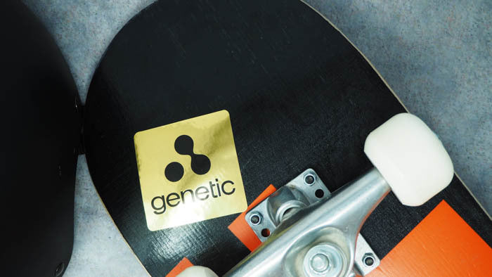 Mirror gold sticker with rounded corners and genetic design applied to skateboard