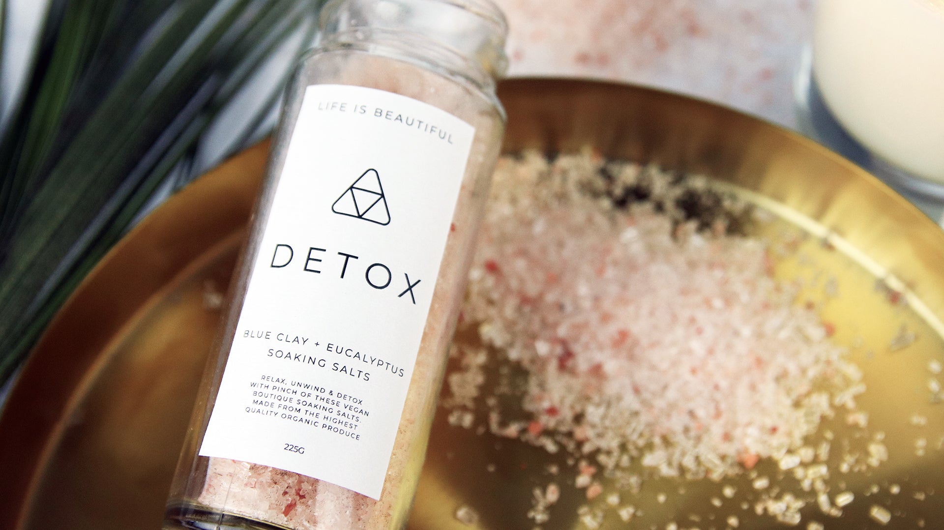 Rectangle biodegradable paper stickers with detox design applied to a clear glass jar filled with soaking salts