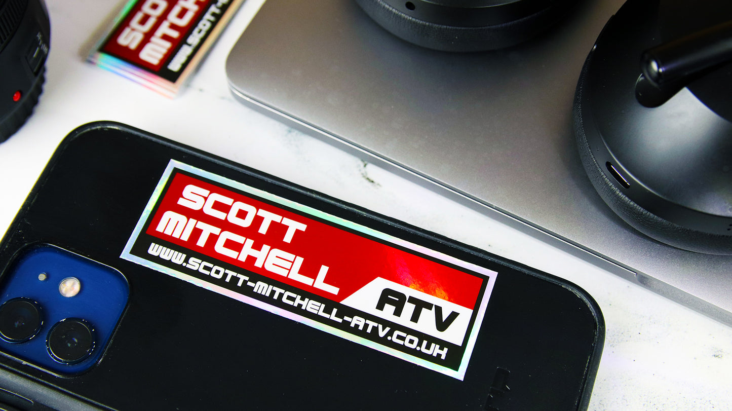 Rectangle holographic label with company logo applied to a black phone