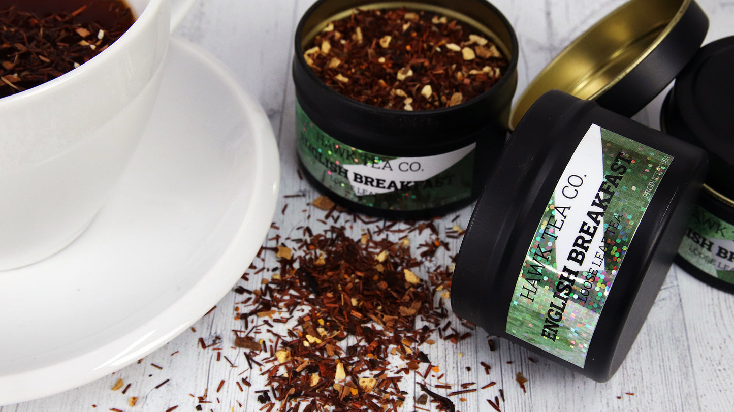 Rectangular glitter stickers applied to black tea tins next to a white mug