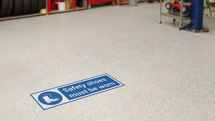 Rectangular safety floor sticker sample applied in a workshop