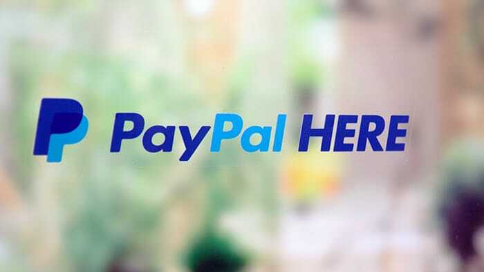 Rectangular static cling sticker with pay here design applied to a window