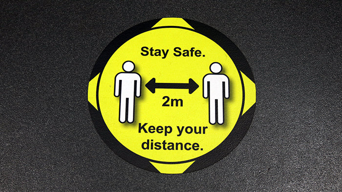 Round social distancing floor sticker applied