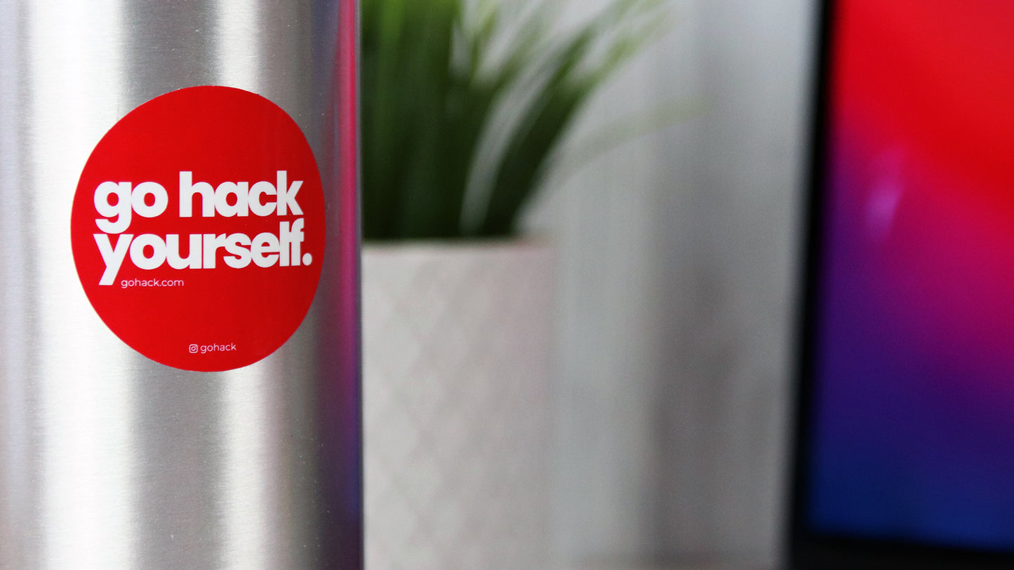 Round white vinyl sticker with go hack yourself design applied to a stainless steel water bottle