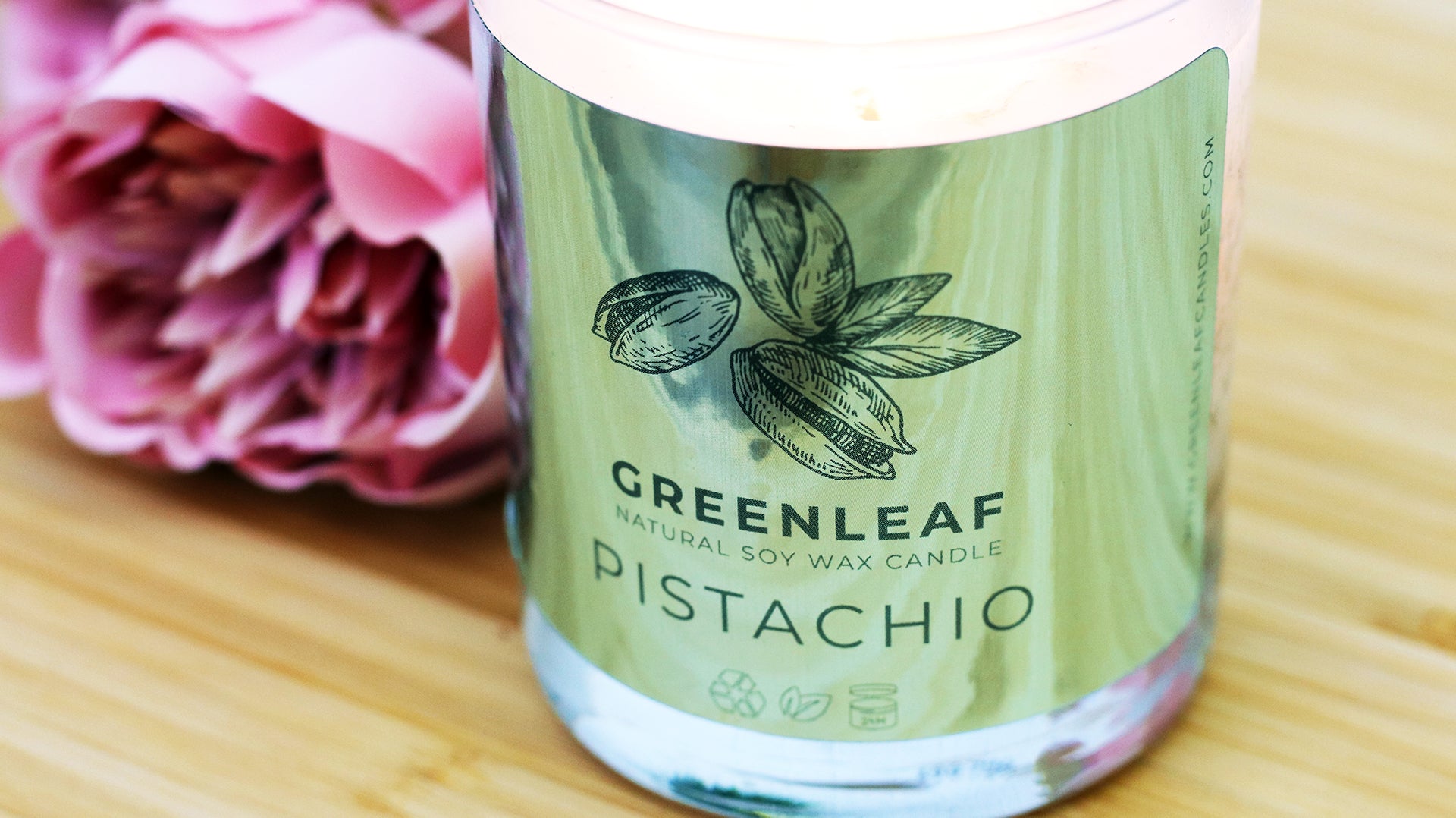 Rounded corner eco-friendly silver sticker applied to a candle jar