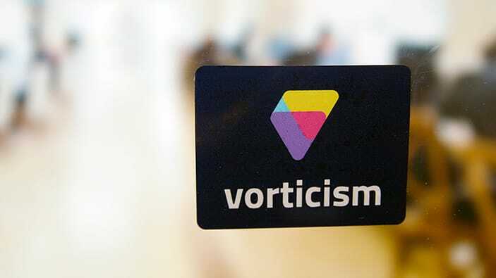 Rounded corner logo sticker with vorticism brand applied to a window