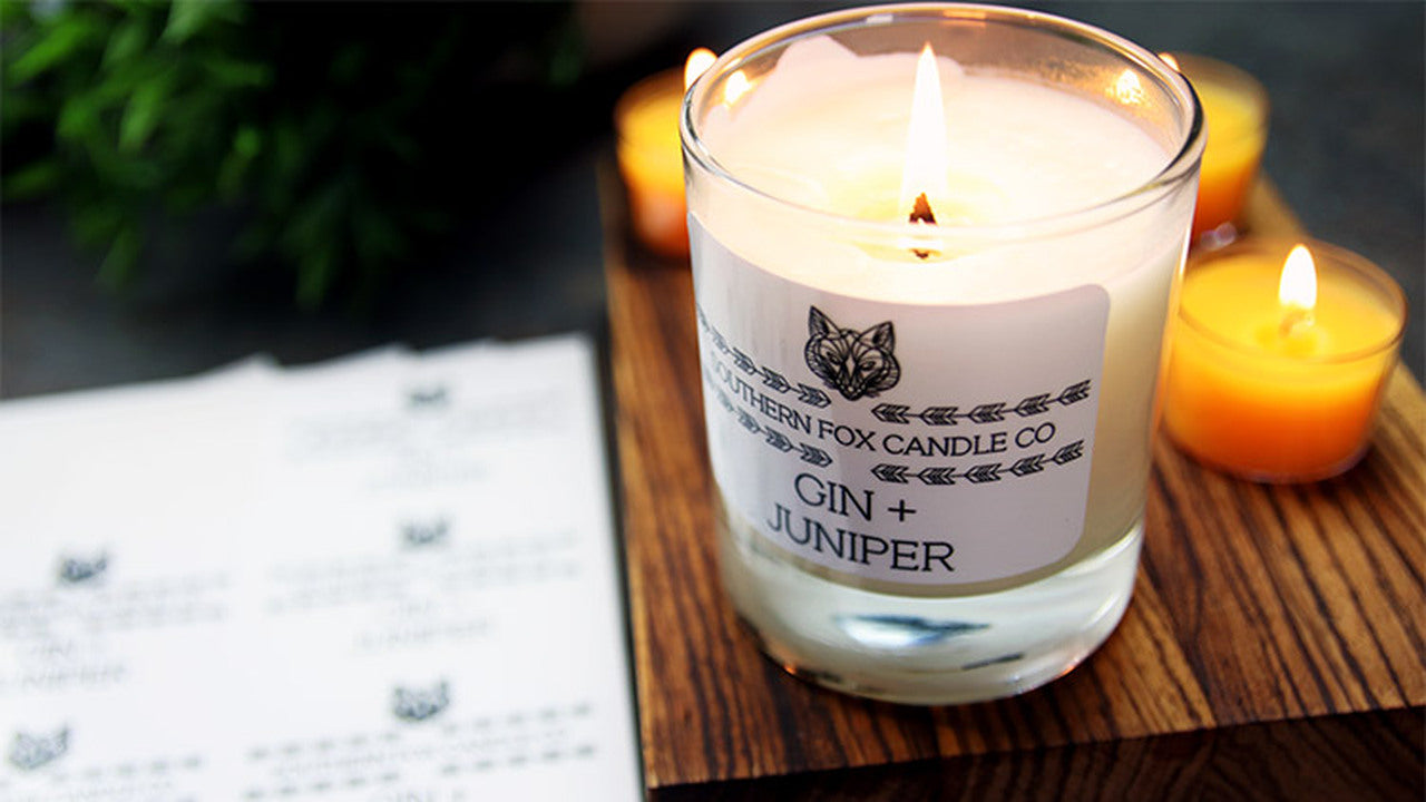 Rounded corner white vinyl sheet labels applied to a clear candle jar