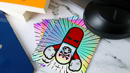 Square holographic sticker with pillman design on a table top