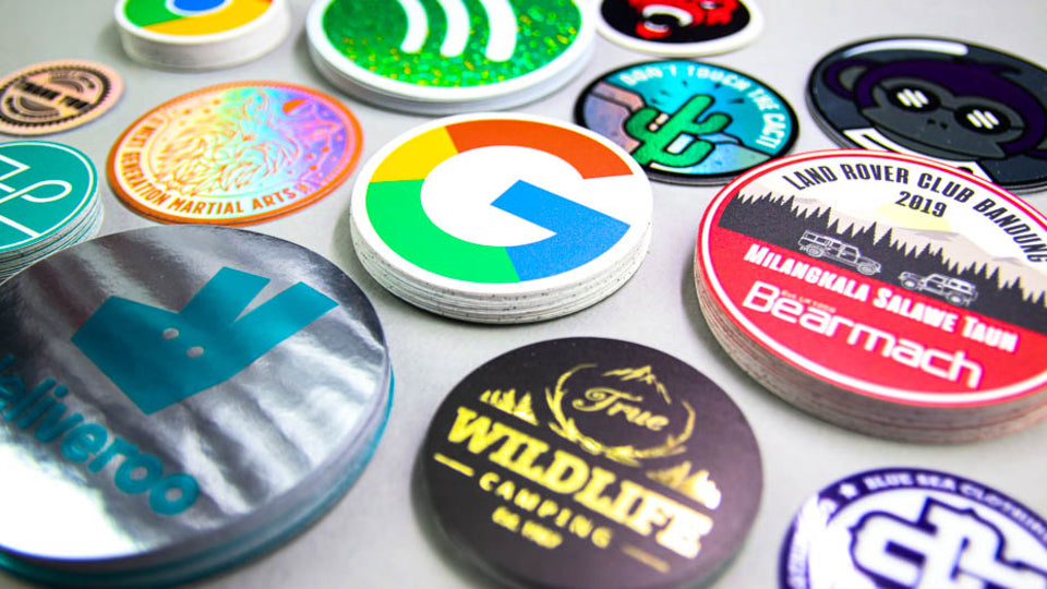 Stack of circular company labels on a white background