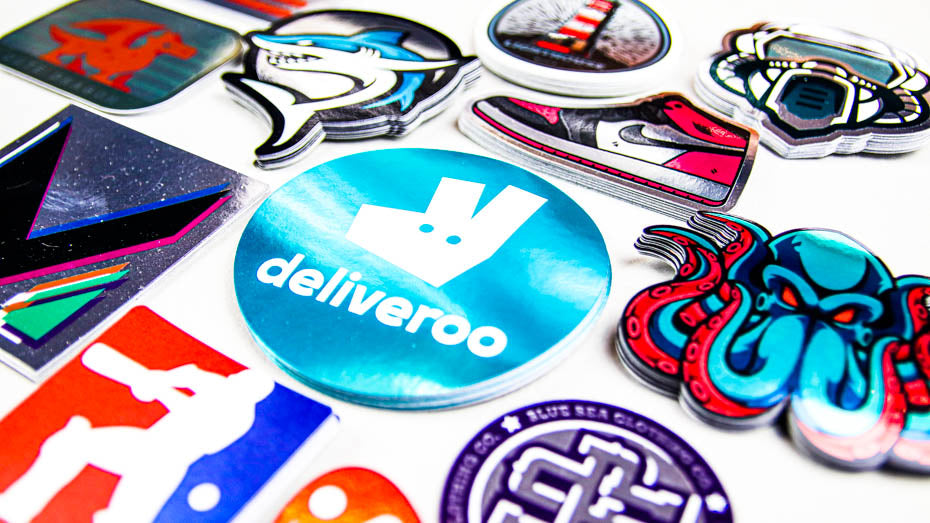 Piles of mirror silver stickers on a light grey table