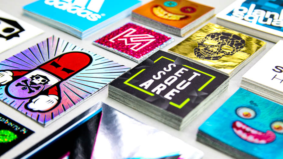 Piles of square stickers on a light grey table