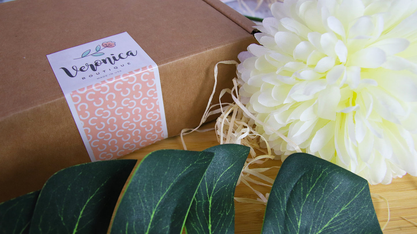 Rectangular eco friendly sticker with Veronica design used as packaging seal on a cardboard box