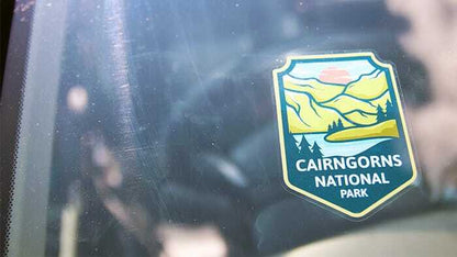 Die cut clear sticker with pop shop logo applied to a car window