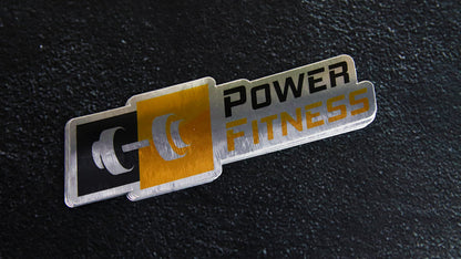 Die cut eco-friendly silver samples with fitness logo on a table top