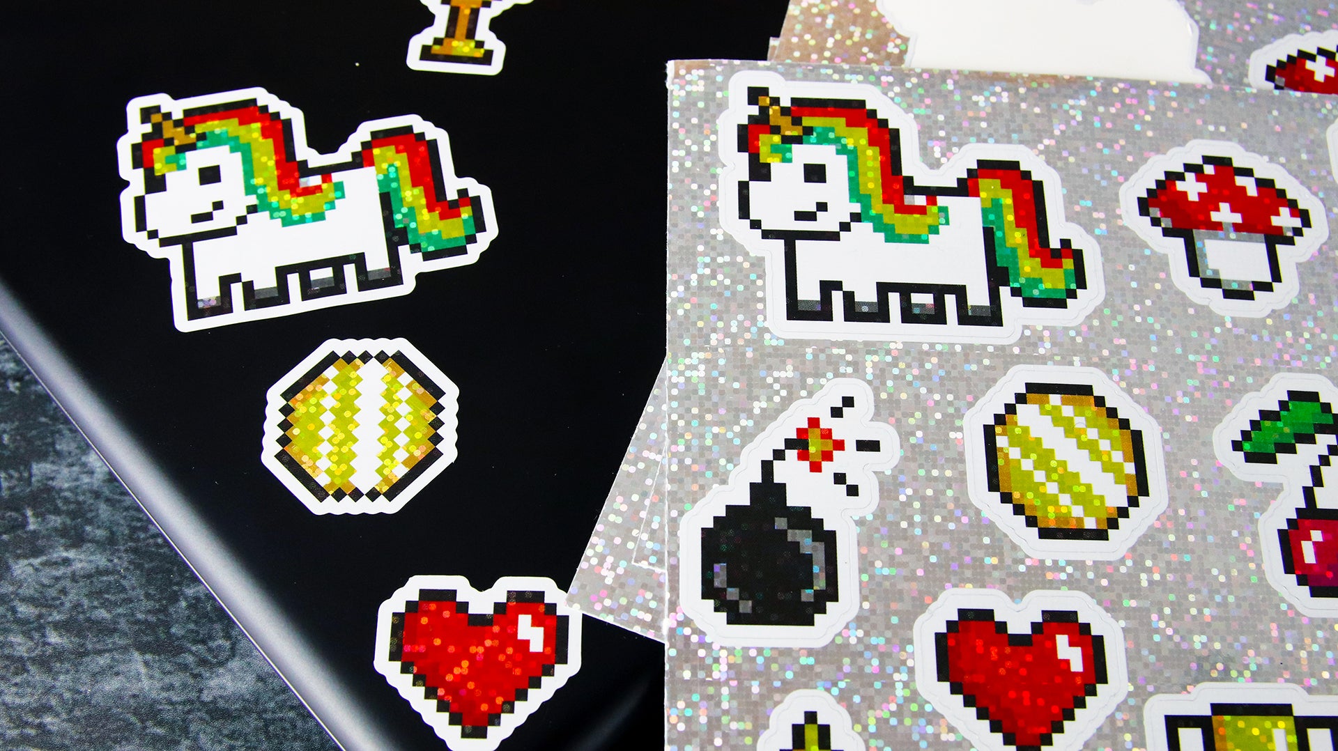 Glitter personalised labels with different cute designs applied to a black laptop