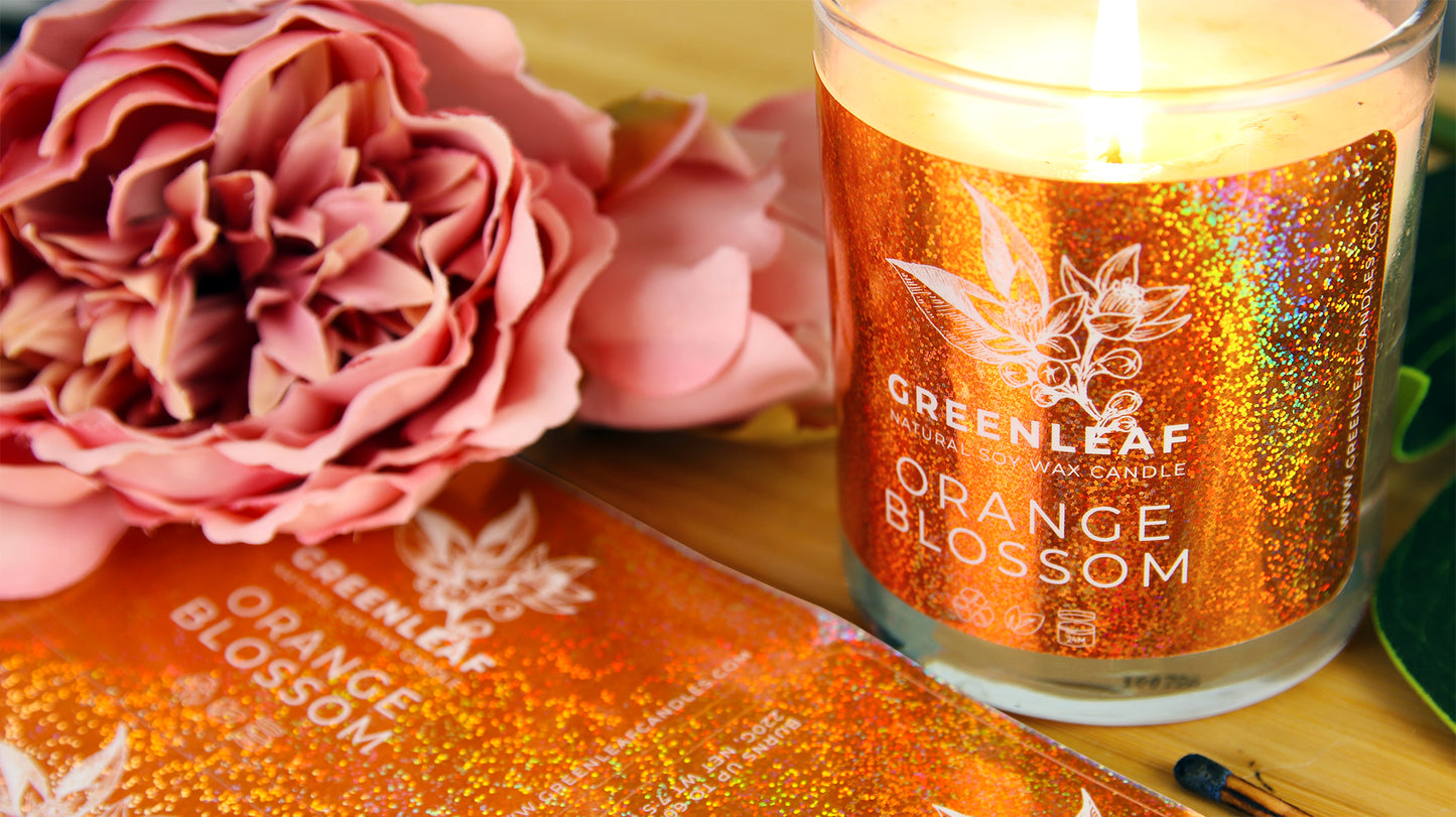 Rounded corner eco-friendly glitter labels with one label applied to a candle